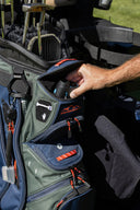 Person taking a range finder out of a range finder pocket on the C-130 golf bag