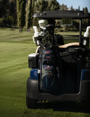 Golf cart with golf clubs and bag on a golf course