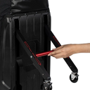 A close-up of a black ClubGlider3 Tour travel bag with a hand adjusting a red handle on the extended black frame, shown against a plain white background.
