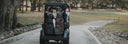 Golf cart on a path with trees and grass in the background