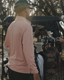 Man getting ready to golf with a golf cart bag and clubs.