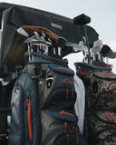 Golf bags with clubs attached to a golf cart
