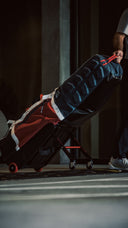 Person pulling a ClubGlider3 on a dark background