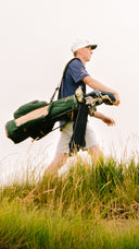 Man carrying the TQR Canvas bag in green
