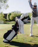 Golfer in action with golf club and bag on a golf course