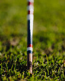 Alignment stick on grass with blurred background