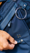 Close-up of a hand zipping a Matchplay Ballistic valuables pocket