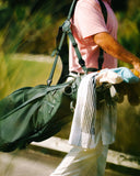 Person carrying a Matchplay Ballistic green golf bag