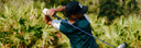 Golfer in action on a golf course with greenery in the background