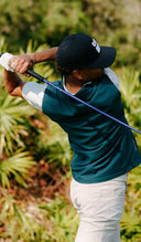 Person playing golf in All Day Vest