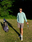 Carter Smith on a golf course with a golf bag in the background