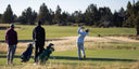 Golfers on a course with Matchplay bags