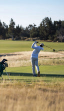 Golfer in action on a golf course with Matchplay bags