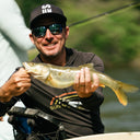 Joel Dahmen smiling while holding a freshly caught fish