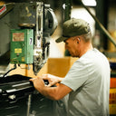Man at rivet machine in the Sun Mountain warehouse