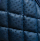 Close-up of a blue quilted hip pad on a golf bag with a diamond pattern