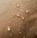 Close-up of a brown canvas fabric surface with small clear water droplets
