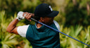 Golfer in action with a blurred green background