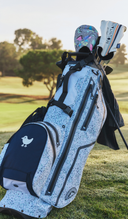 Golf bag with clubs on a golf course