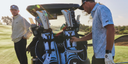 Two men with golf bags on a golf course