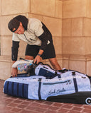 Man loading a golf bag into a SMS x Bad Birdie ClubGlider